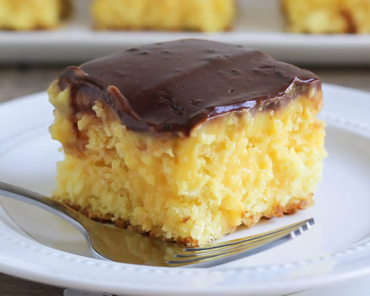Boston cream poke cake close up image.