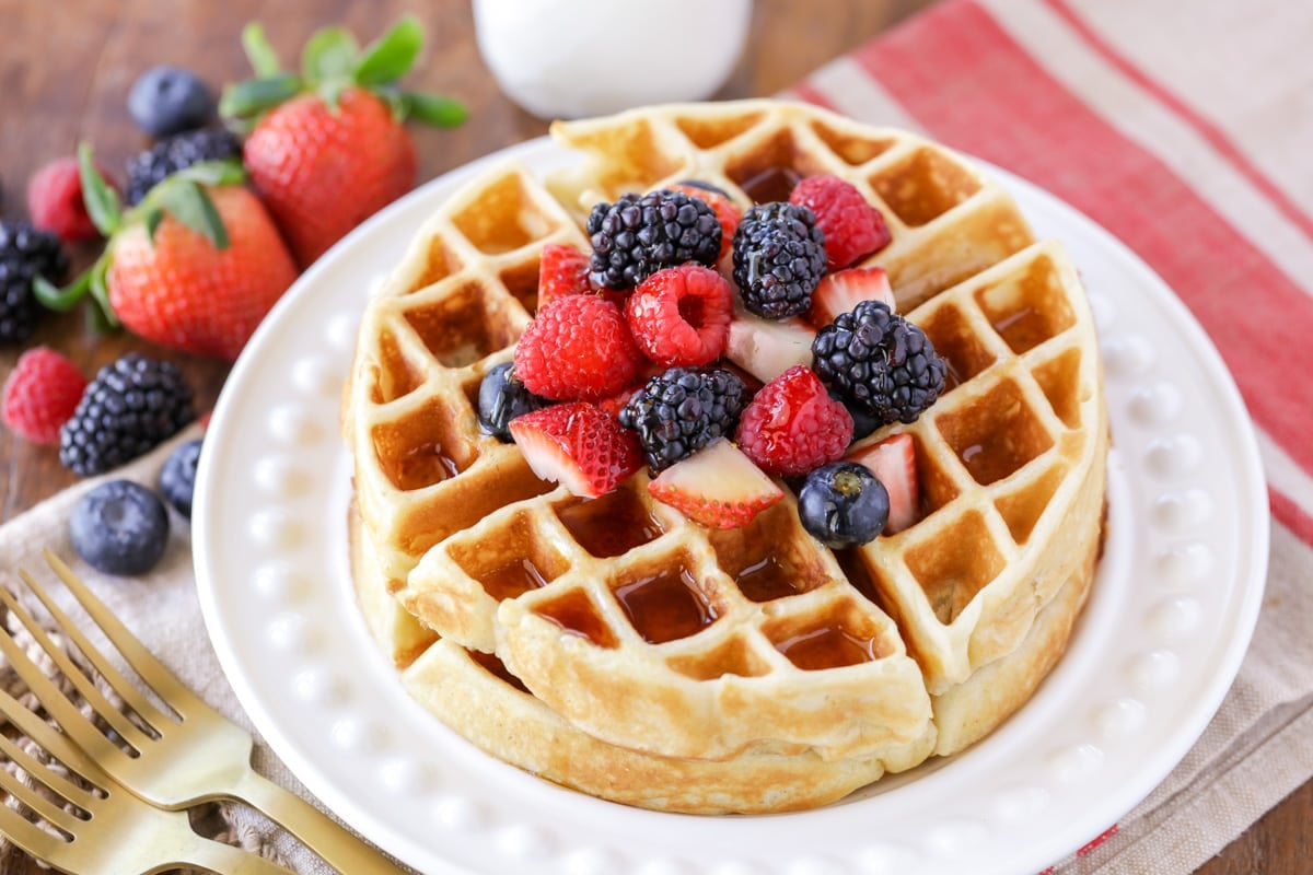 Crisp, fluffy Belgian Waffles are an easy way to start your day with a smile. They will be your go-to homemade waffles - I promise! Two stacked Belgian waffles topped with fresh berries.